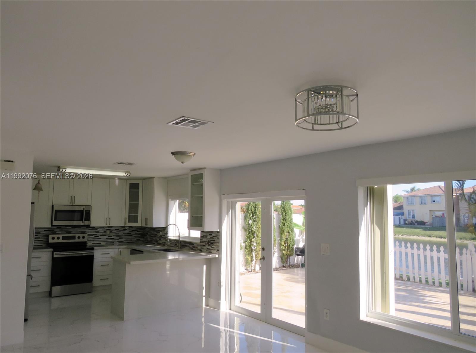 16330 Southwest 102nd Street Miami, FL 33196 - Photo 7 of 30 a kitchen with a refrigerator and a sink