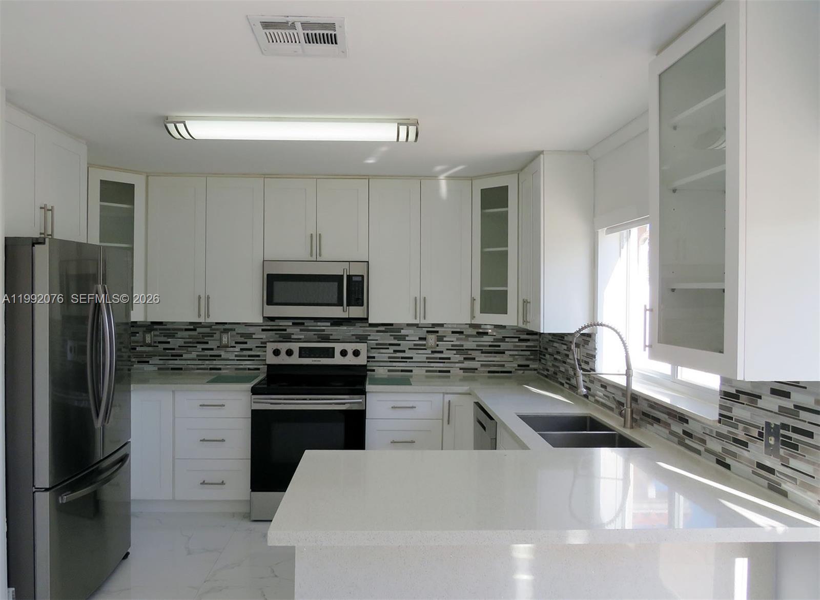 16330 Southwest 102nd Street Miami, FL 33196 - Photo 8 of 30 a kitchen with a sink stove and refrigerator
