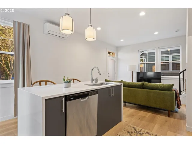 a living room with furniture a window and wooden floor