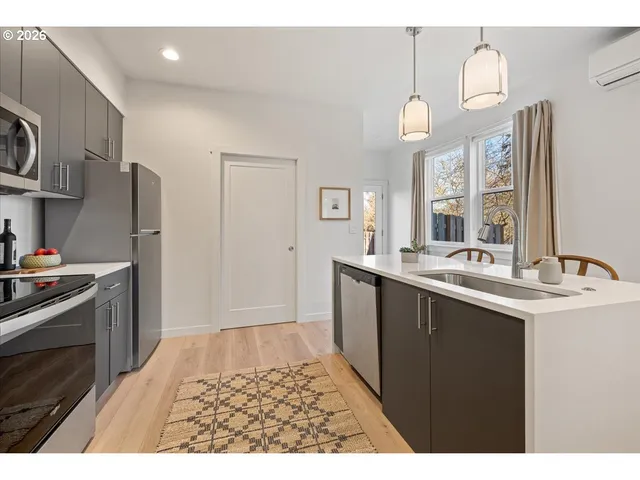 a kitchen with a sink and a refrigerator