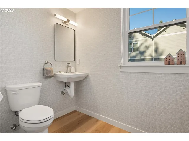 a bathroom with a toilet a sink and mirror