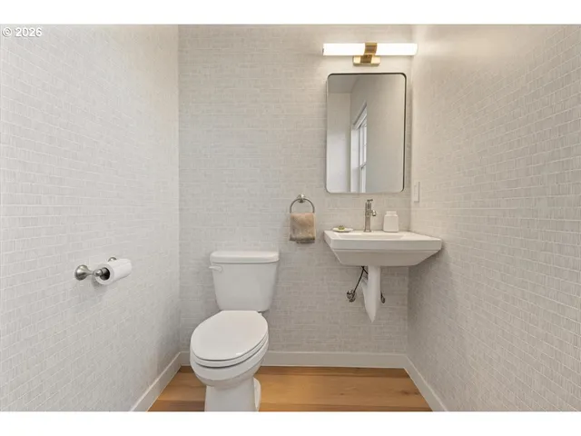 a bathroom with a sink a toilet and mirror