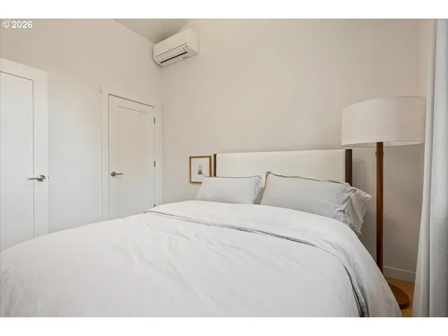 a bedroom with a bed and a night stand