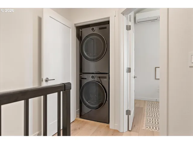 a view of a hallway with washer and dryer