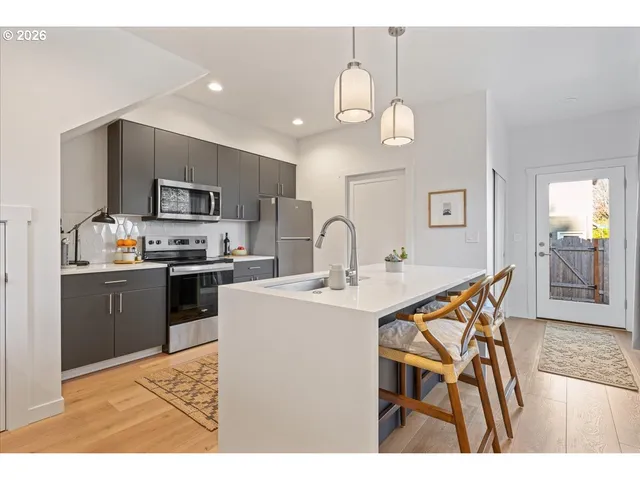 a kitchen with stainless steel appliances kitchen island granite countertop a sink and cabinets