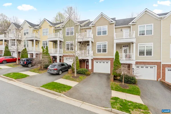 a view of multiple houses with cars parked
