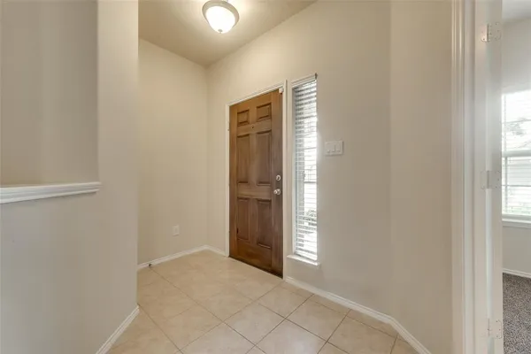 a view of an empty room with window and closet area