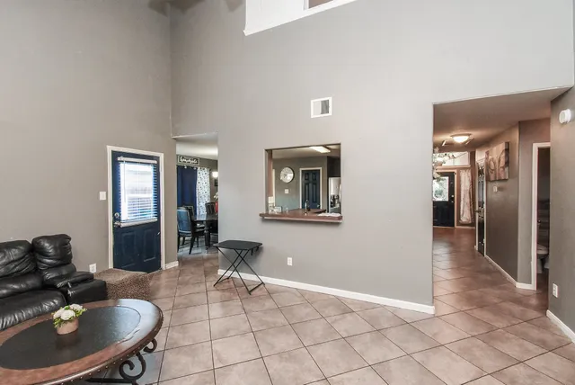 a dining room with furniture a chandelier and window