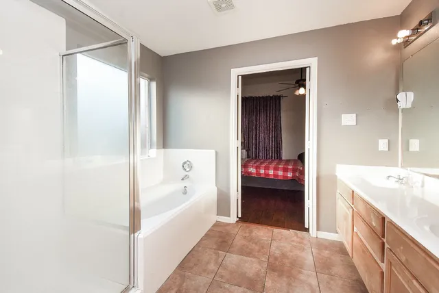 a white bath tub sitting next to a shower