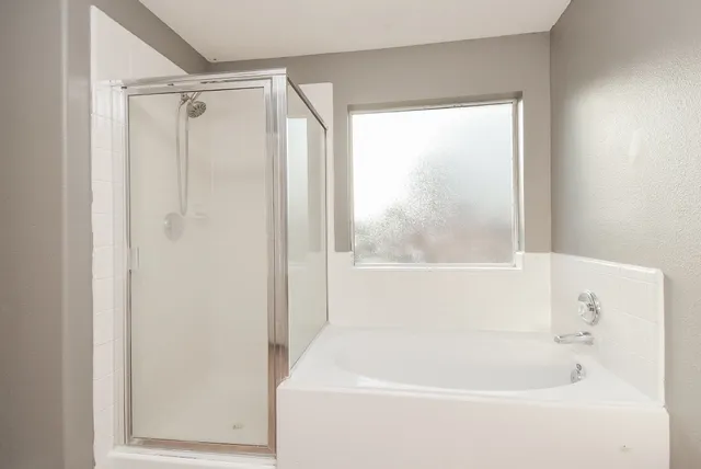 a spacious bedroom with a bed and a chandelier