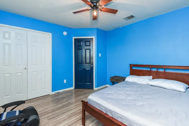 a bedroom with a bed and a dresser