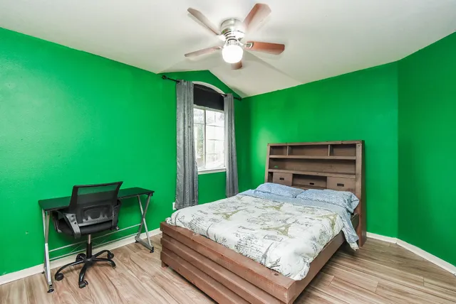 a bedroom with a bed and a bookshelf