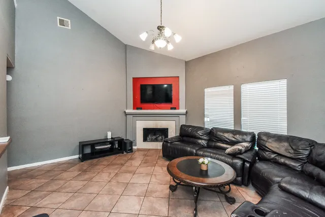 a living room with furniture a dining table and chairs