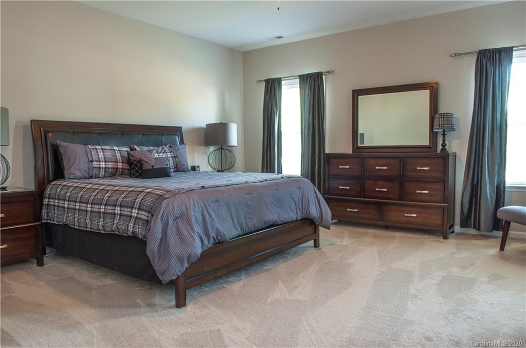 5554 Braddock Ml Way Lancaster, SC 29720 - Photo 14 of 33 a bedroom with a bed and a flat tv screen on dresser