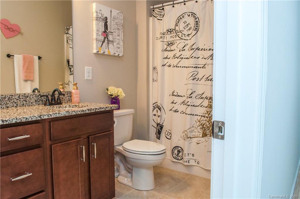 5554 Braddock Ml Way Lancaster, SC 29720 - Photo 18 of 33 a bathroom with a granite countertop toilet sink and mirror