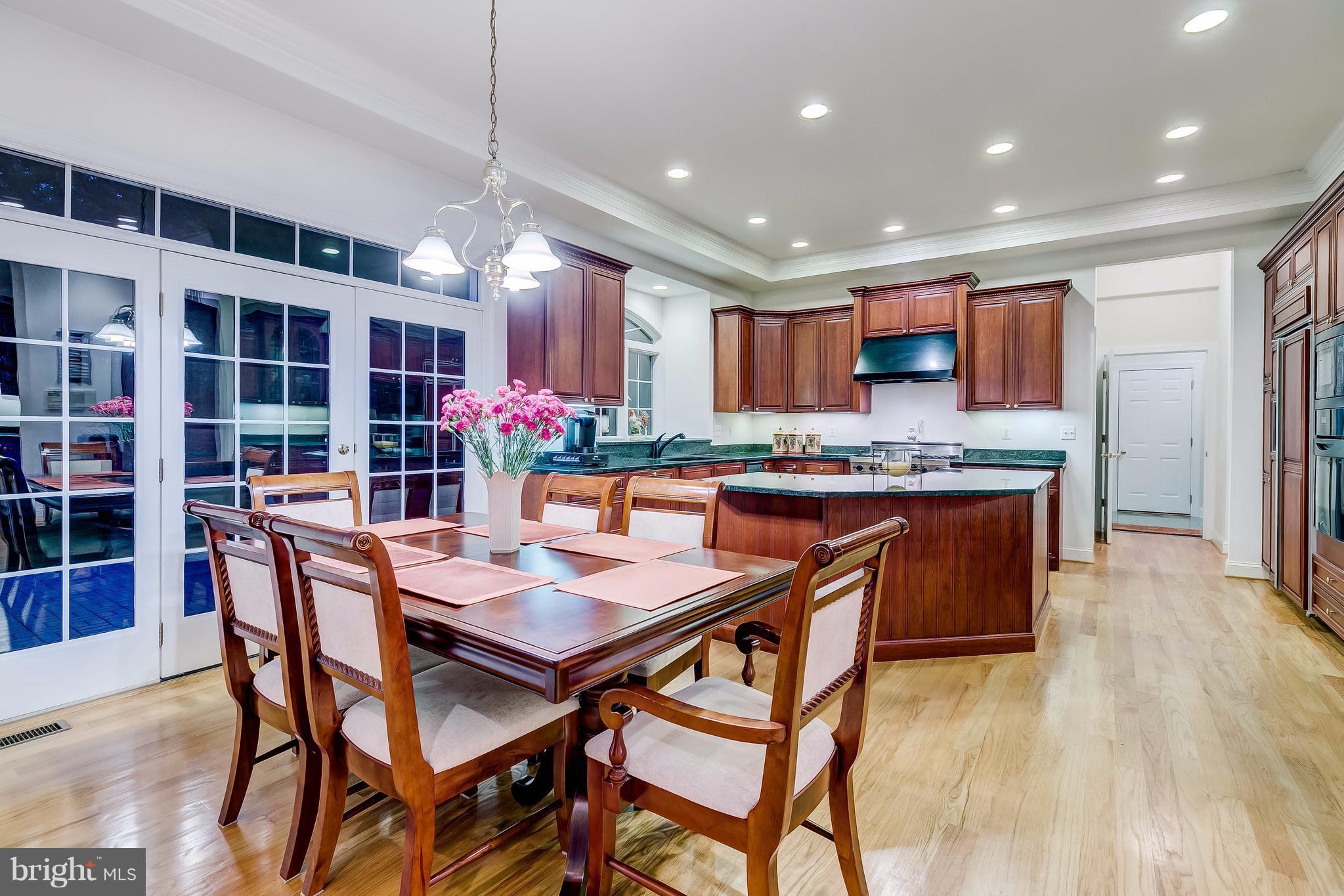 1128 Western Run Road Cockeysville, MD 21030 - Photo 11 of 30 a kitchen with stainless steel appliances granite countertop a kitchen island a stove a dining table and chairs