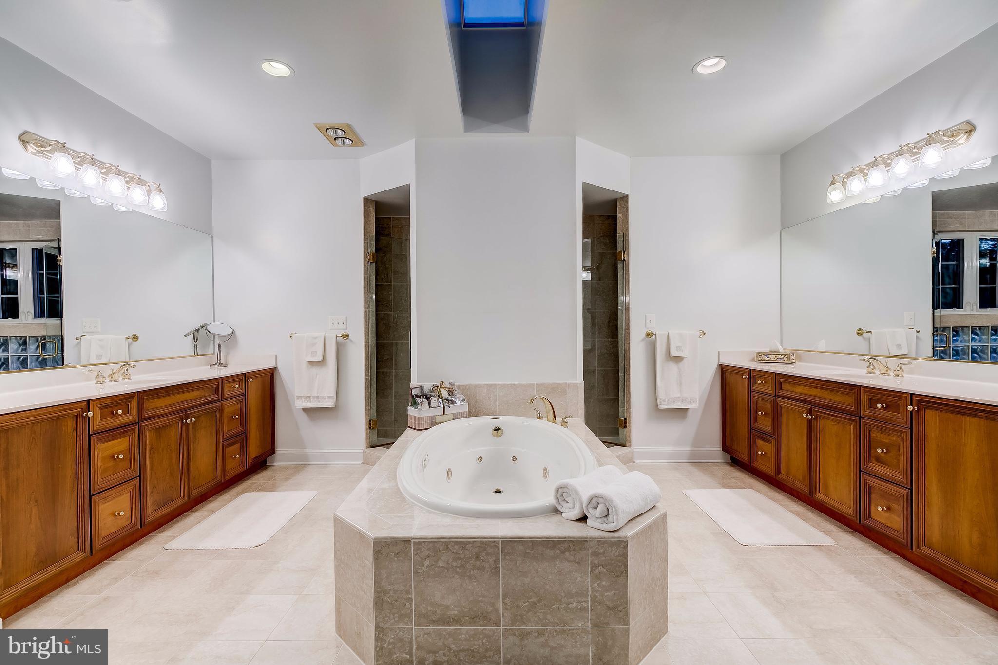1128 Western Run Road Cockeysville, MD 21030 - Photo 13 of 30 a spacious bathroom with a tub sink and a mirror