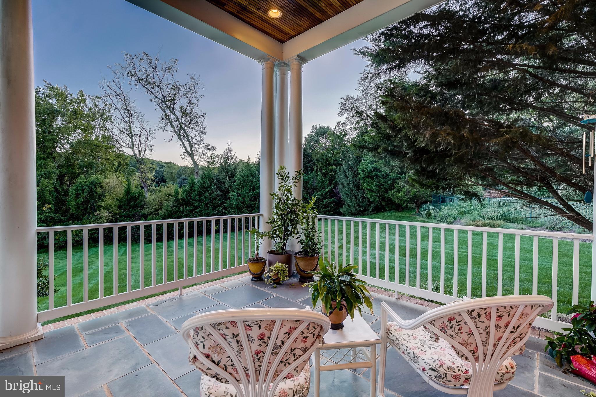 1128 Western Run Road Cockeysville, MD 21030 - Photo 5 of 30 a balcony with wooden floor table and chairs