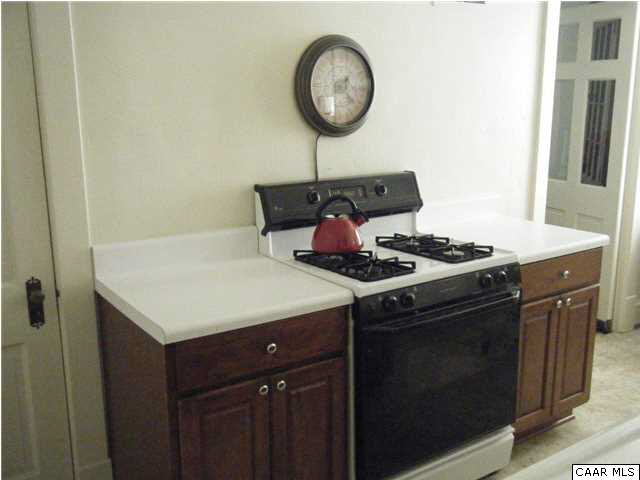 425 Madison Road Stanardsville, VA 22973 - Photo 23 of 23 a kitchen with a stove and a clock on the wall