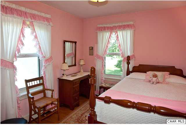 425 Madison Road Stanardsville, VA 22973 - Photo 6 of 23 a bedroom with a bed and wooden floor