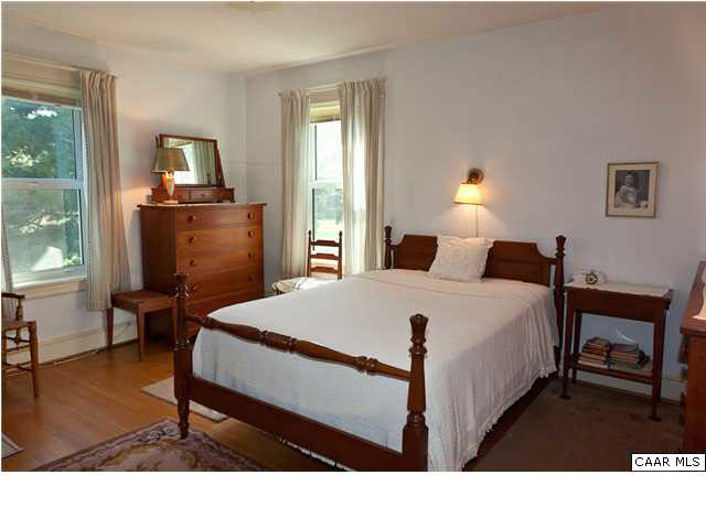 425 Madison Road Stanardsville, VA 22973 - Photo 8 of 23 a bedroom with a bed a lamp and a window