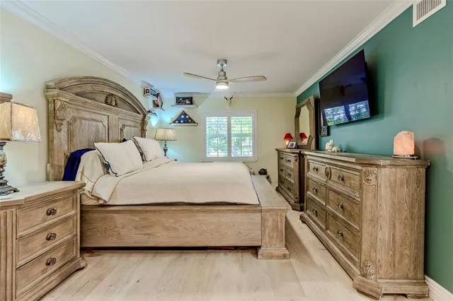 a bedroom with bed and a chandelier