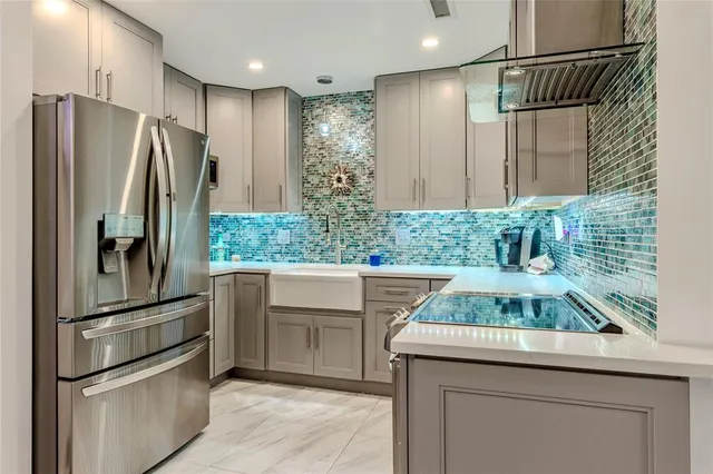 a kitchen with kitchen island a counter and stainless steel appliances