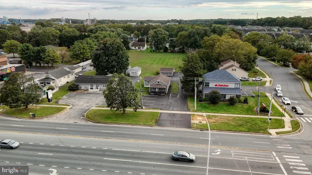 an aerial view of a house with a garden and lake view