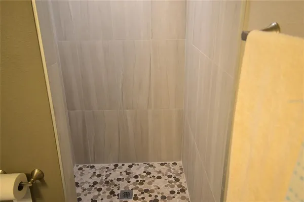 a bathroom with a tub and shower