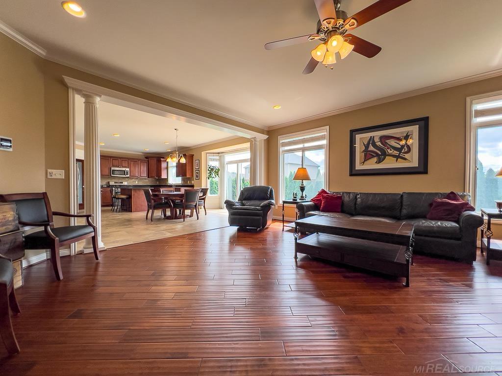 16070 Moore Park Road Macomb, MI 48044 - Photo 16 of 76 Open to the kitchen & dining area with no obstruction. Bordered by 2 subtle decorative columns.