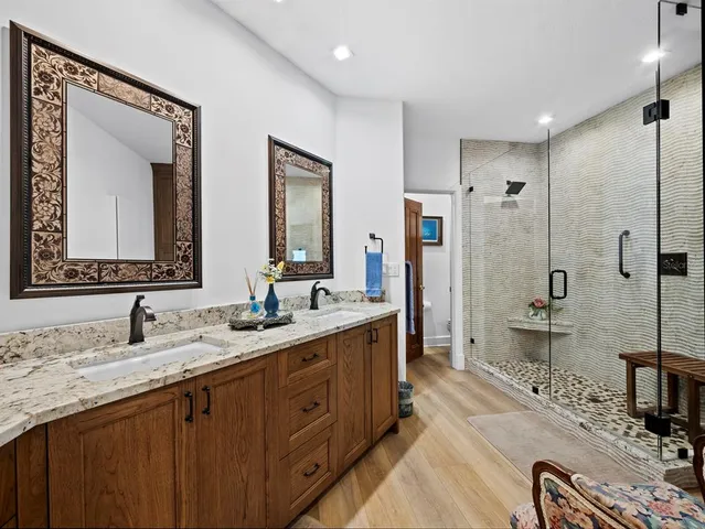 a bathroom with a double vanity sink mirror double and shower