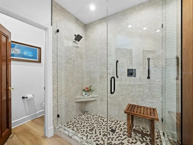 a bathroom with a toilet and a shower