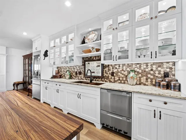 a kitchen with stainless steel appliances a sink and cabinets