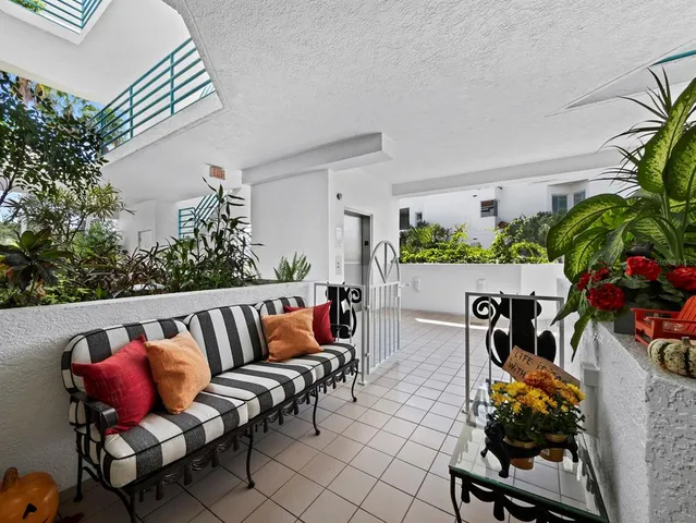 a view of a livingroom with furniture and a kitchen