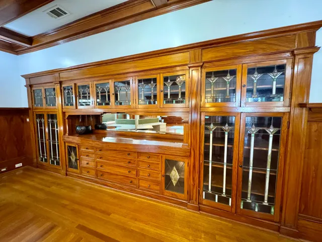 a front view of a building with glass windows and brick walls