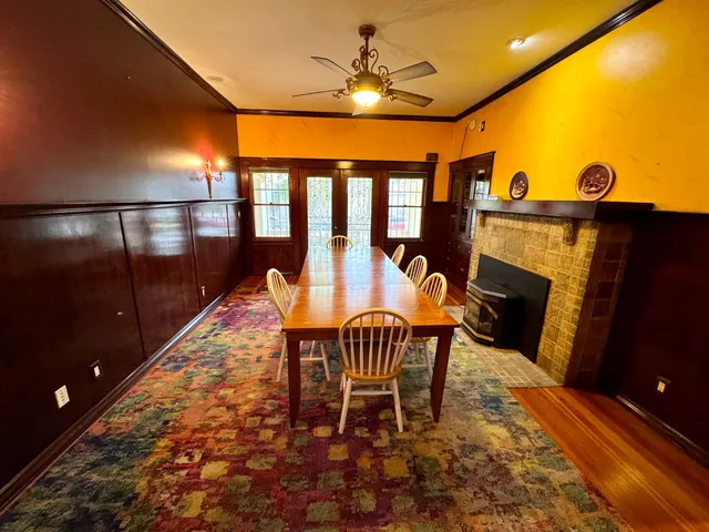 a dining room with furniture and a floor to ceiling window