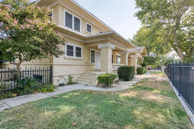 a view of a house with backyard and sitting area