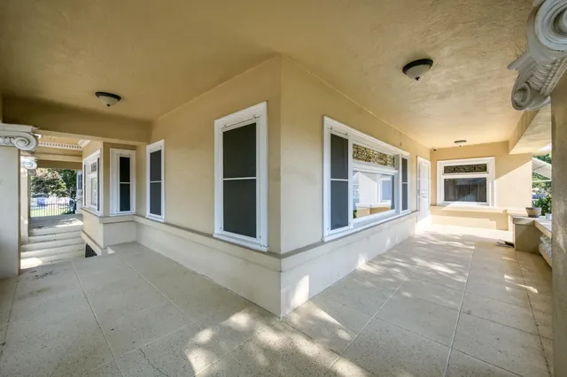 a view of a house with a backyard and a tree