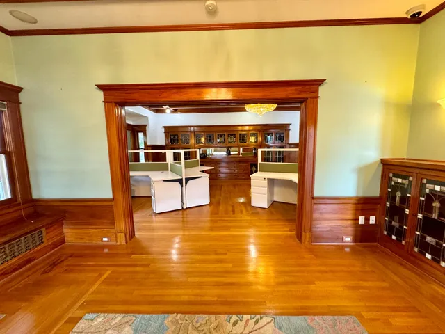 a view of a living room with furniture and wooden floor