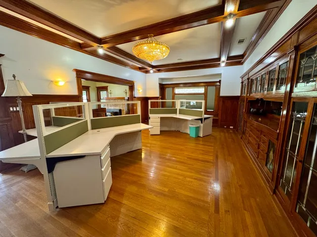 a living room with stainless steel appliances furniture and a kitchen view