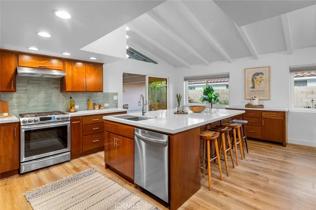 a kitchen with a sink stove and cabinets