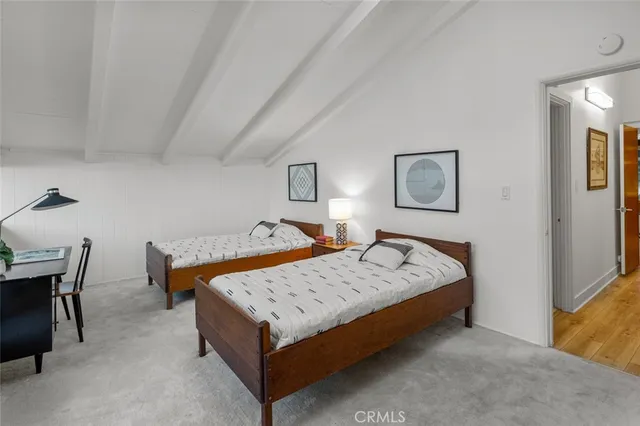 a bed sitting in a bedroom chandelier and table