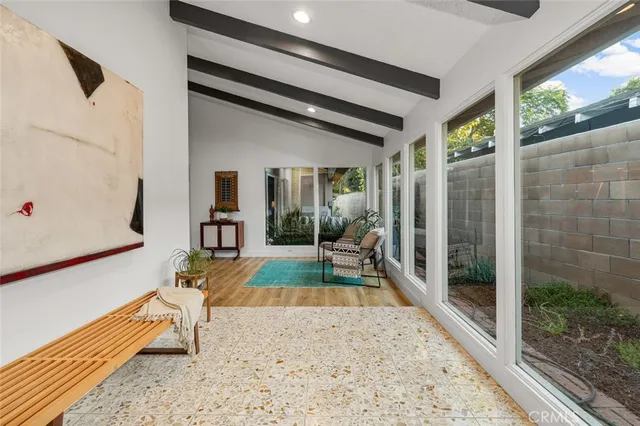 a view of a porch with furniture and floor to ceiling window