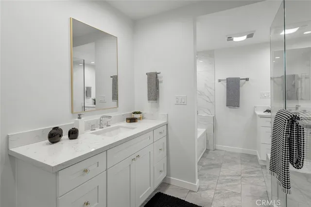 a bathroom with a shower sink and mirror