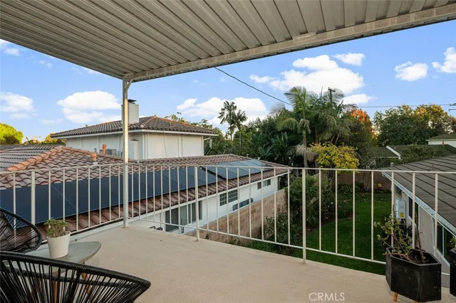 a view of a house with backyard sitting area and garden