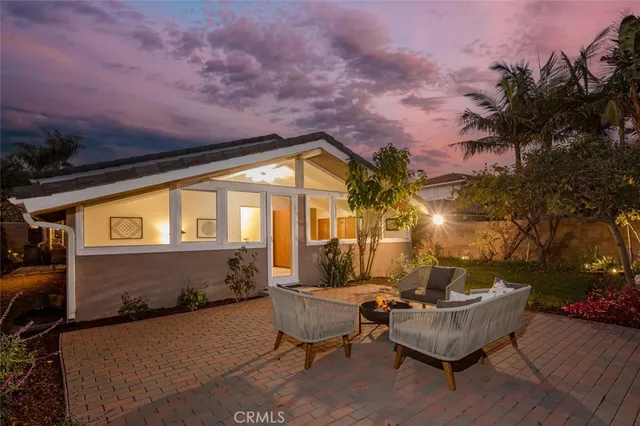 a terrace with outdoor seating and trees