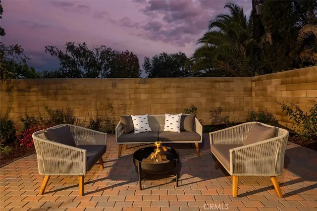 a view of a house with backyard and sitting area