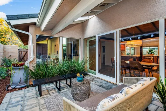a view of a backyard with plants and a patio