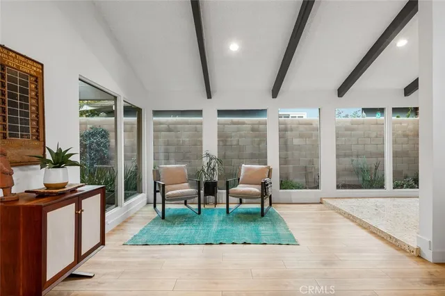 a living room with furniture tv and a table