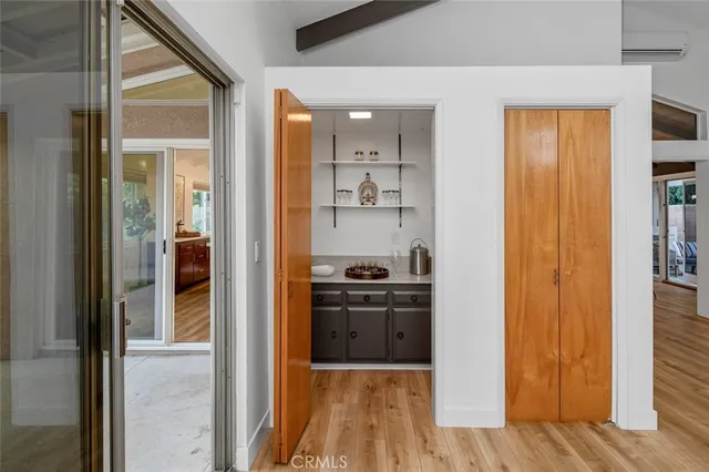 a kitchen view with a sink a refrigerator and wooden floor